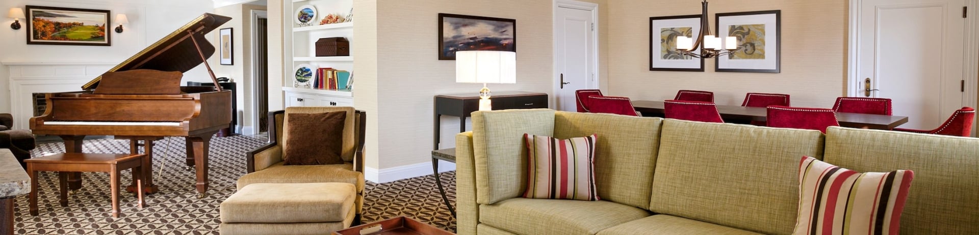 living room with sectional and piano that is connected to the dining room