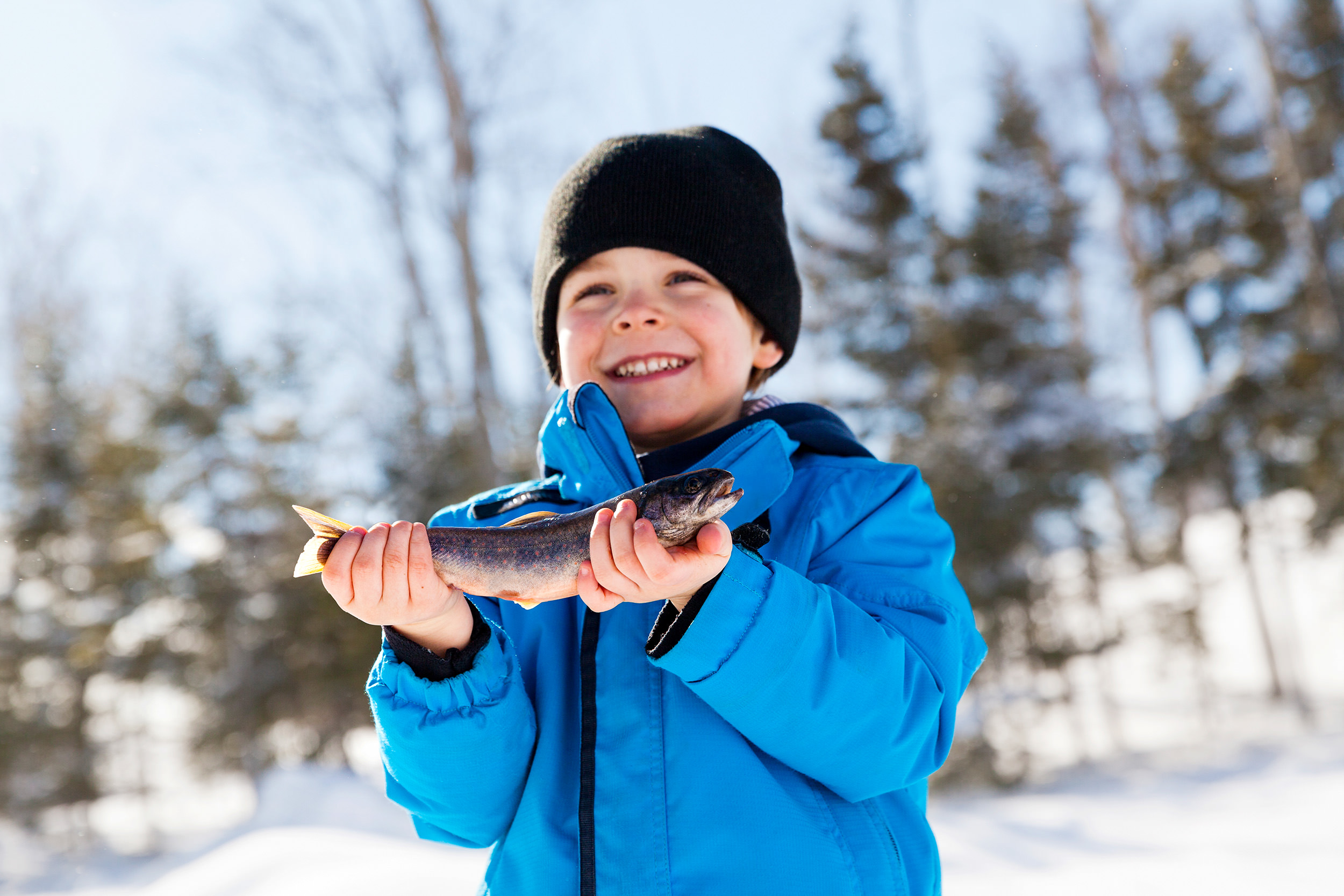 little boy holding a fish