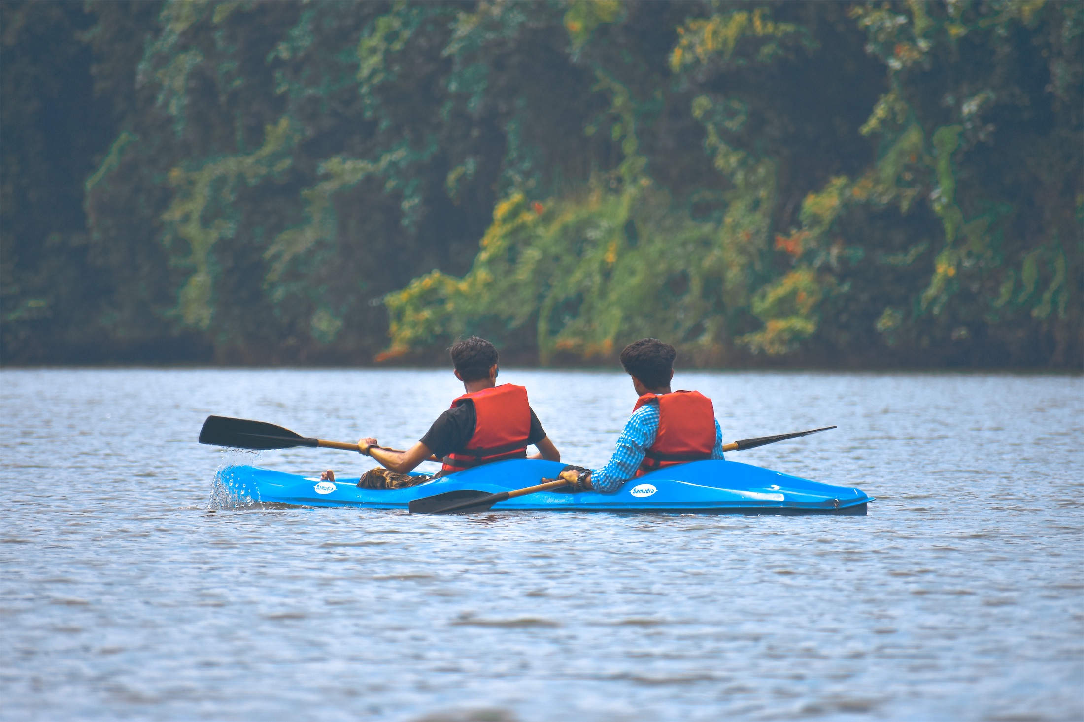 men in a two seated kayak