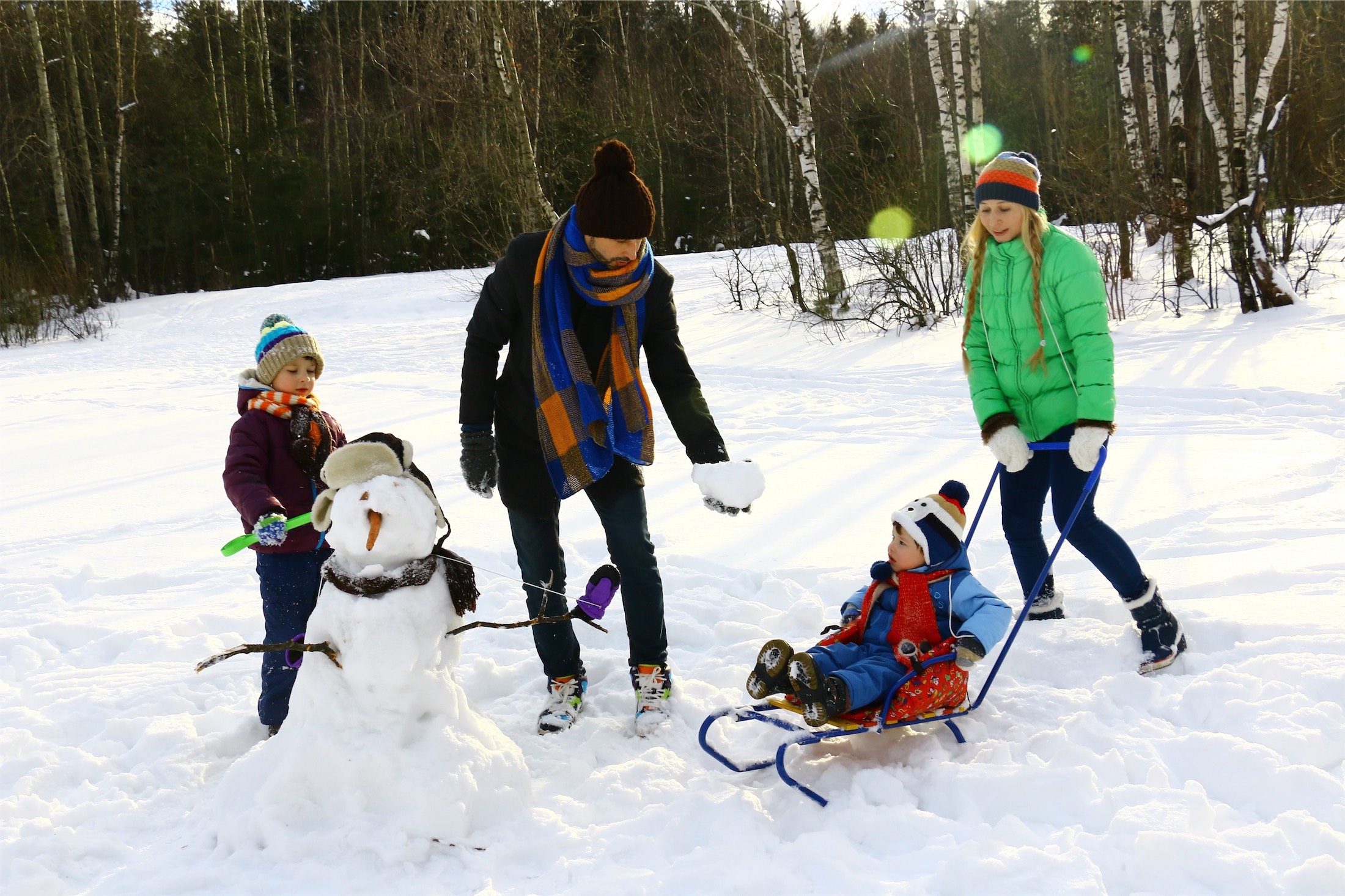 family building a snowman