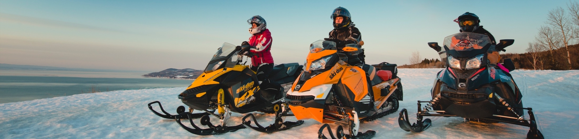 friends skidooing on a mountain