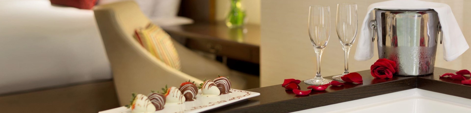 chocolate covered strawberries and a bottle of champagne on the jacuzzi ledge