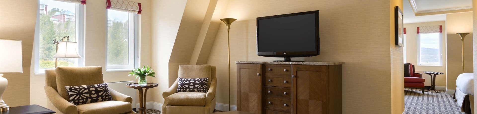 living room with sofa and two chairs with view of bedroom