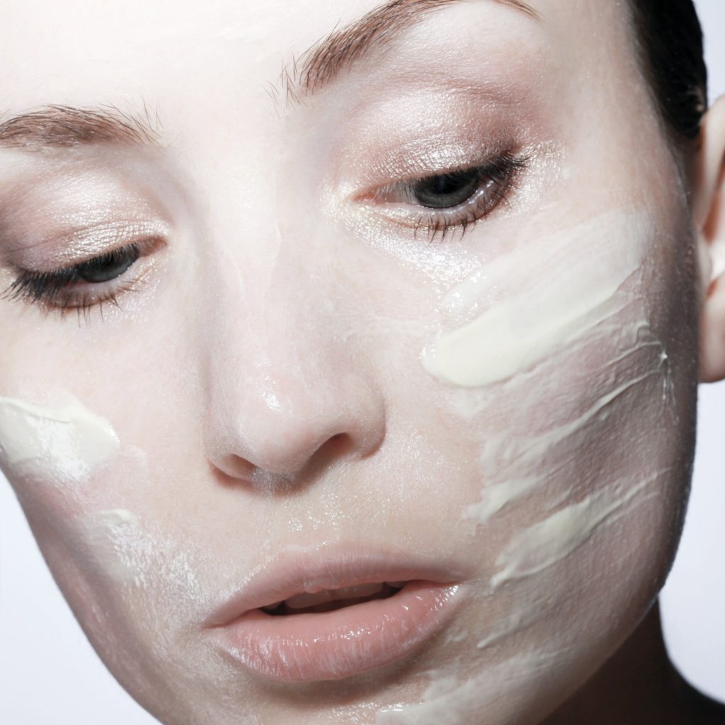 close up of a woman with lotion on her face